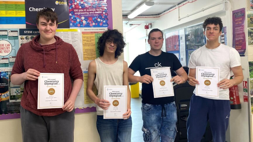 4 male students holding up certificates