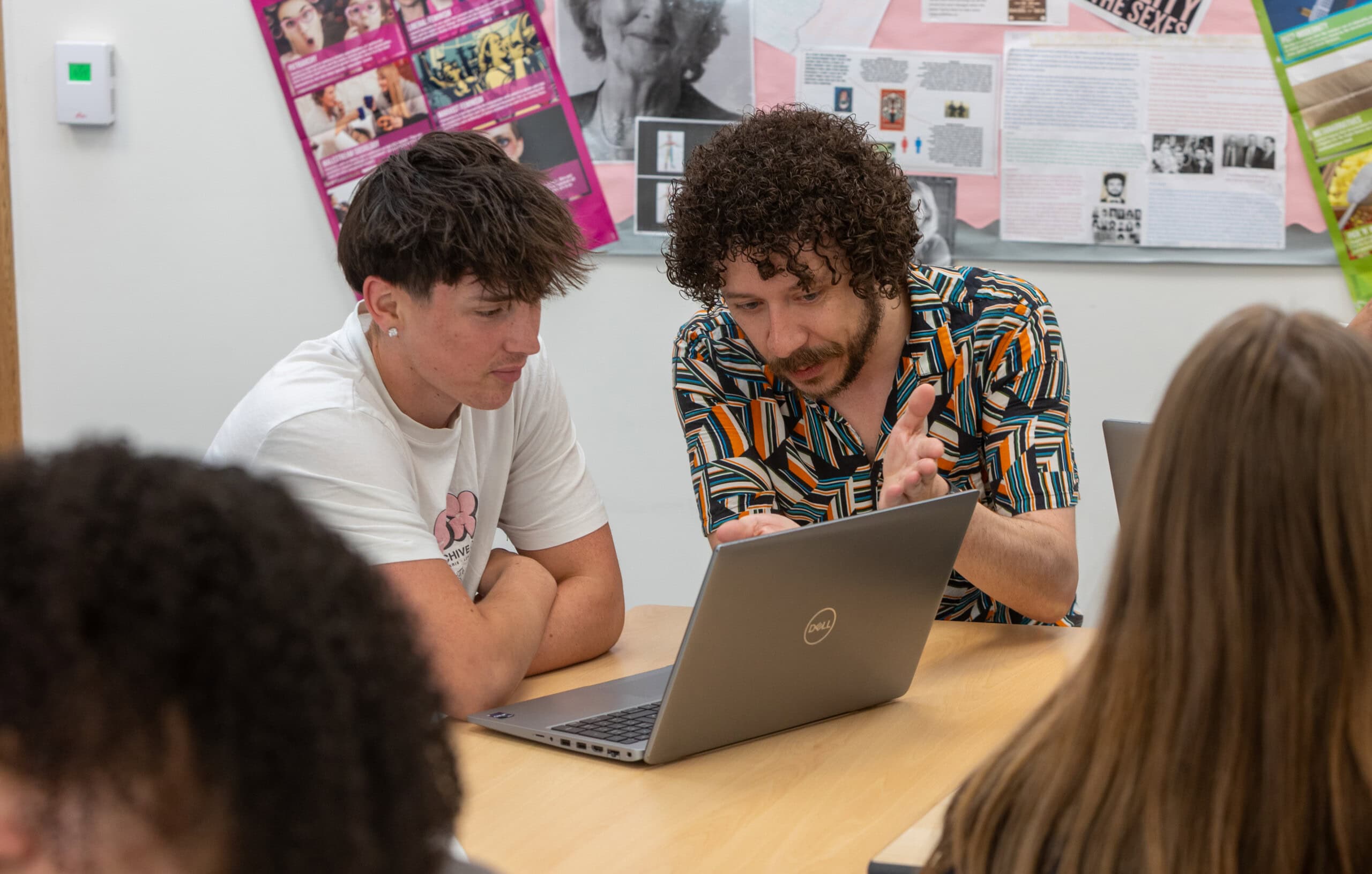 jack working at a table with a student
