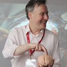 Dr Guy Sutton holding a model brain