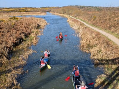 Students kayaking down a river