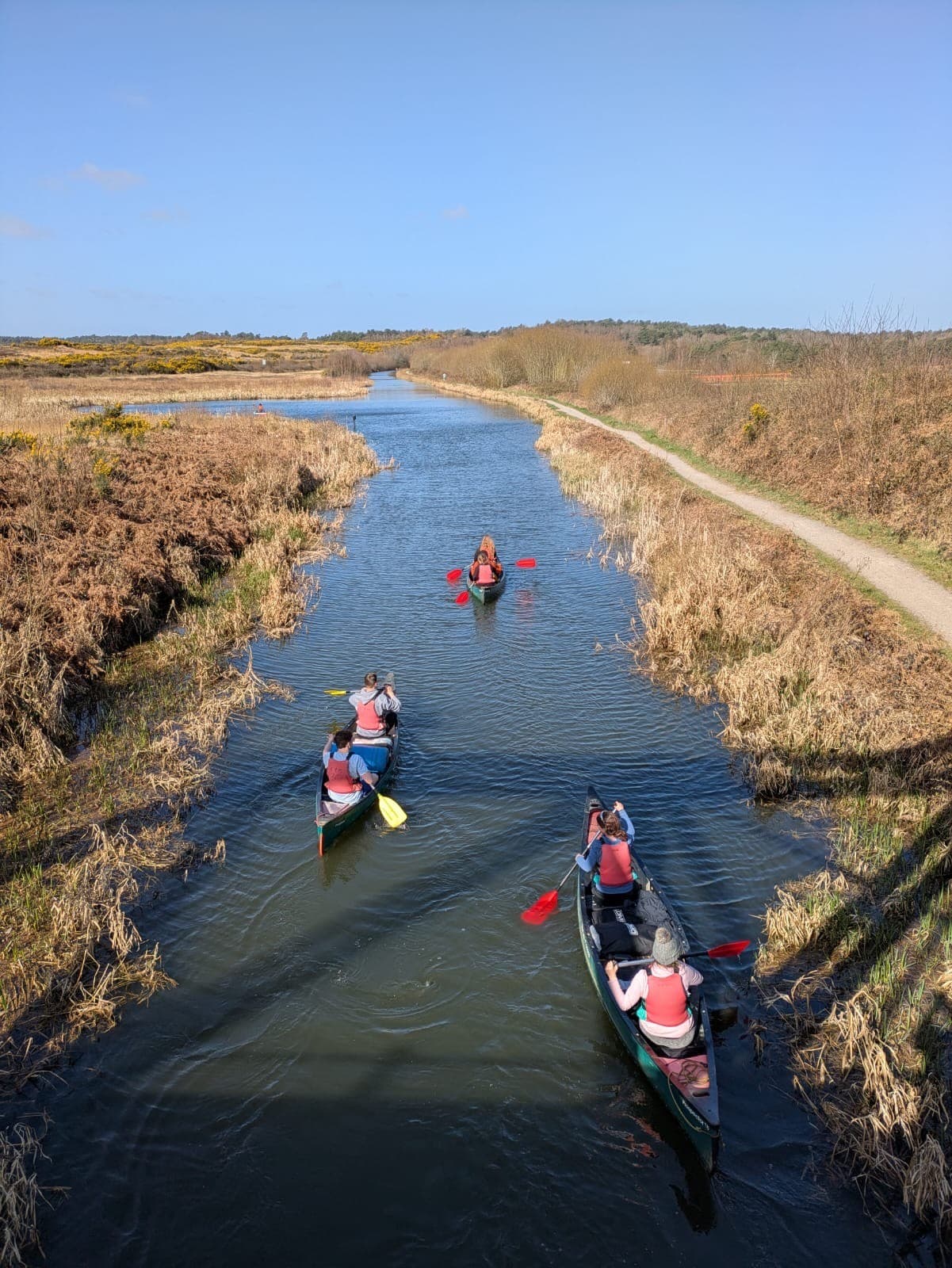 Students kayaking down a river