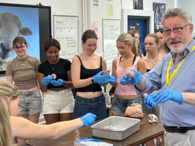 Dr Guy Sutton showing a dissected brain to Students