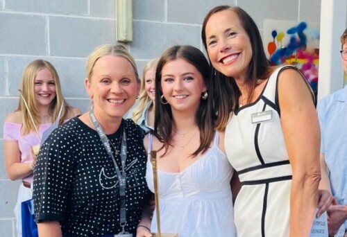 Fine ARt student is flanked by her two art teachers at Art Show