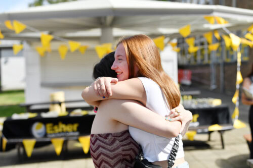 two female students hug at Esher College Results Day 2025