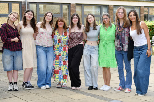 students and two female teachers stand in a line celebrating Esher College Results Day 2025 029