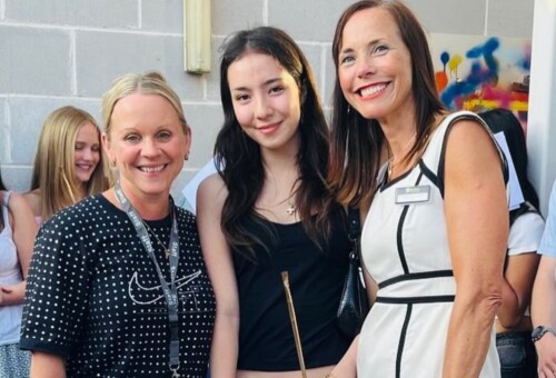 Art student stand inbetween her two teachers smiling Art Result