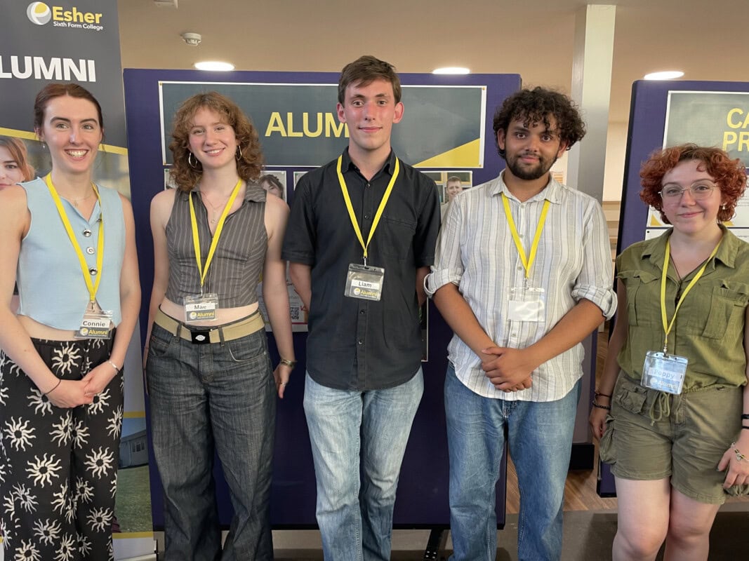 5 Alumni standing infront of the Alumni Stand at the 2025 college open evening