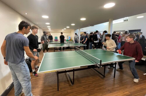 Students playing ping pong in the cafe