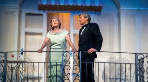 A male and female actors performing on a balcony in Private Lives on the West End Stage