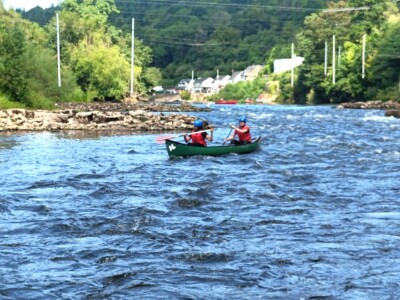 Students Canoeing In Rapids