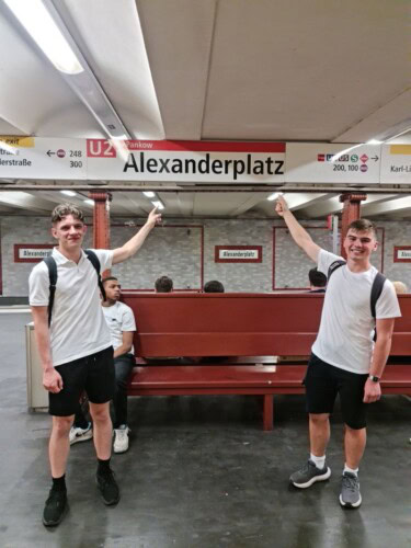 Students Poiting To Alexanderplatz Sign In Berlin