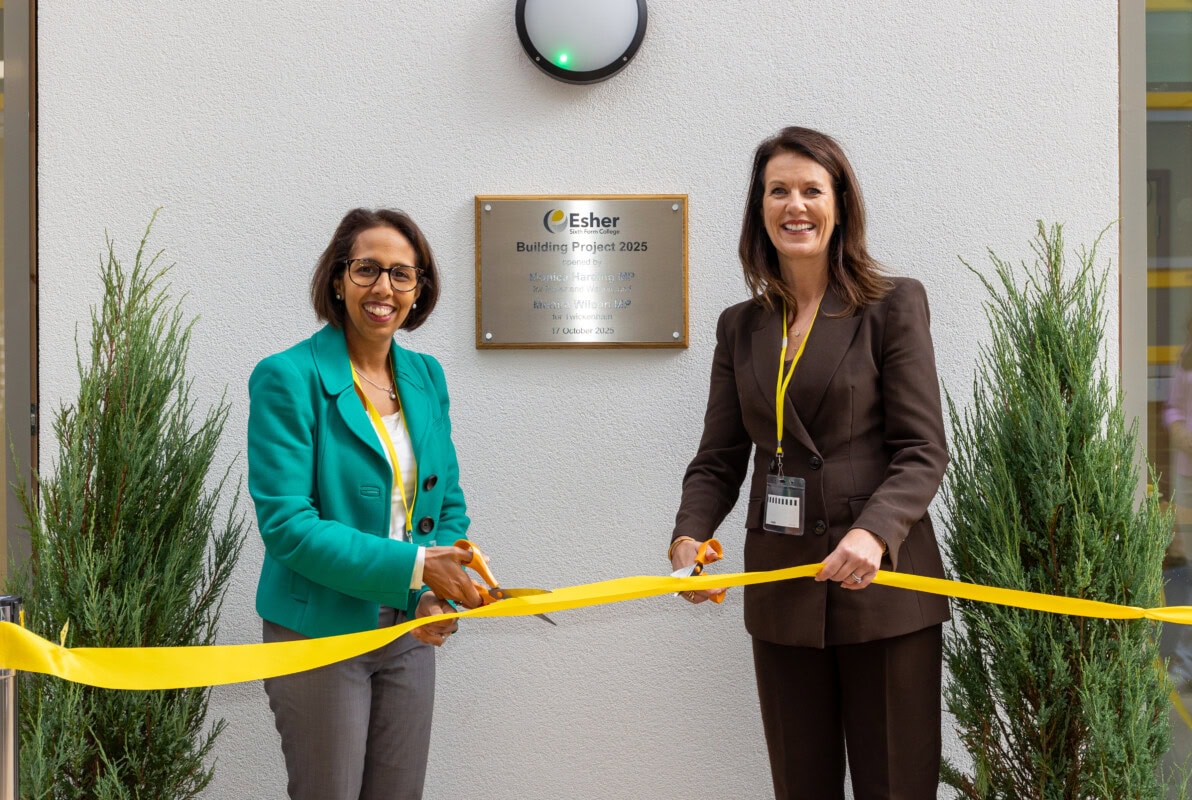 Monica Harding and Munira Wilson cutting a yellow ribbon