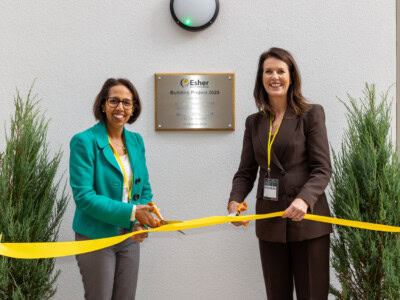 Monica Harding and Munira Wilson cutting a yellow ribbon