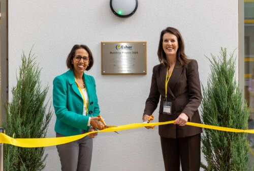 Monica Harding and Munira Wilson cutting a yellow ribbon