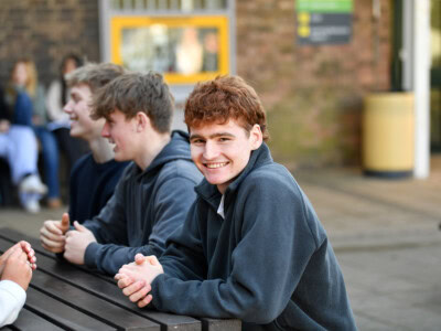 College Student at a bench with other students