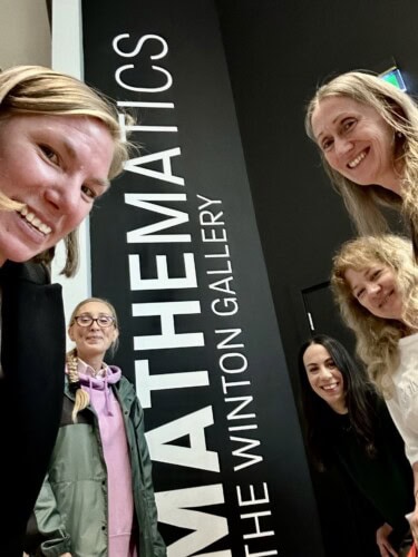 Maths TEachers peers into the camera while on a mathematics conference