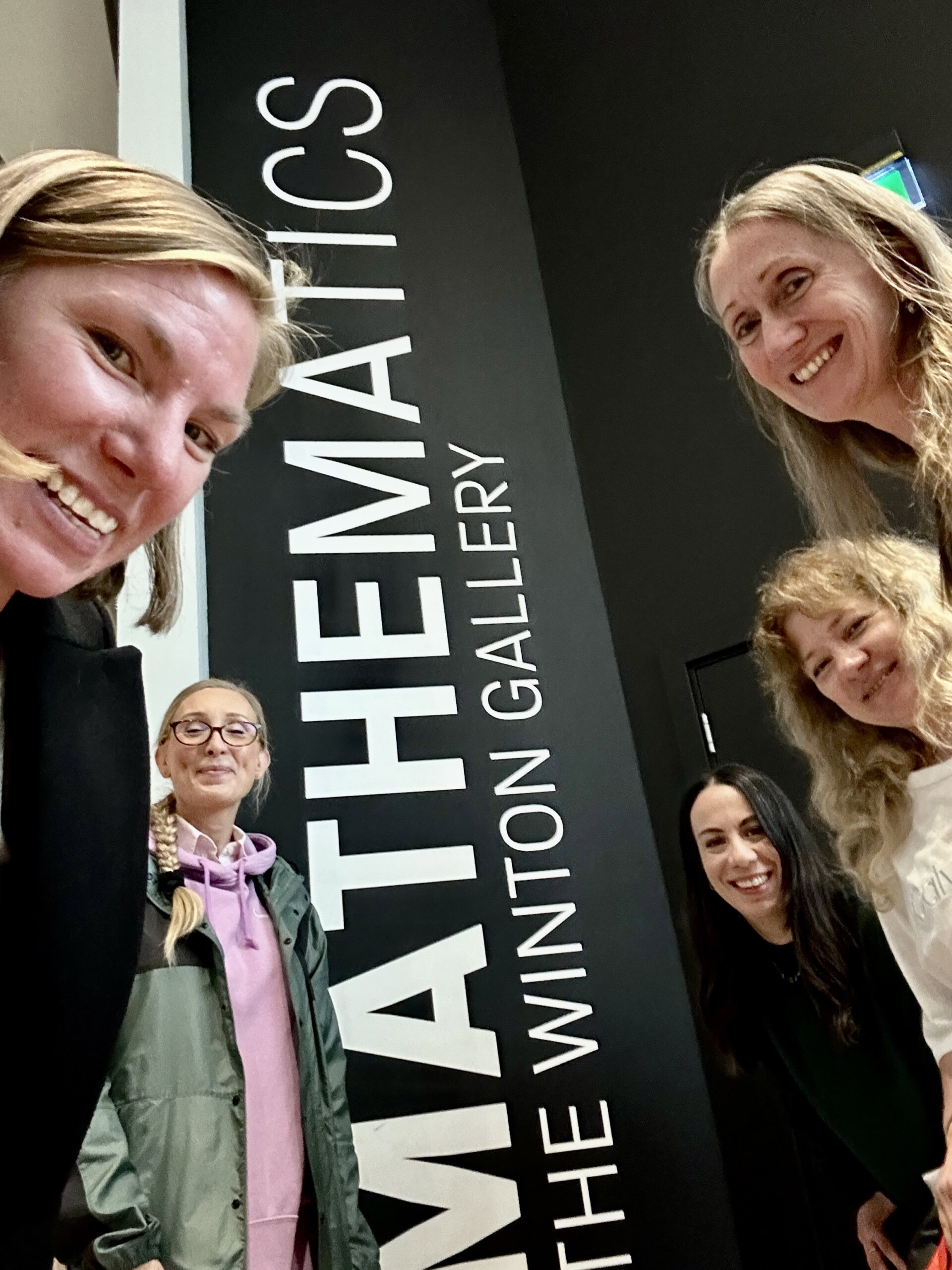Maths TEachers peers into the camera while on a mathematics conference