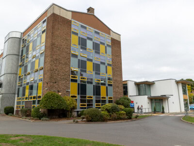 College Tower With Students Crossing