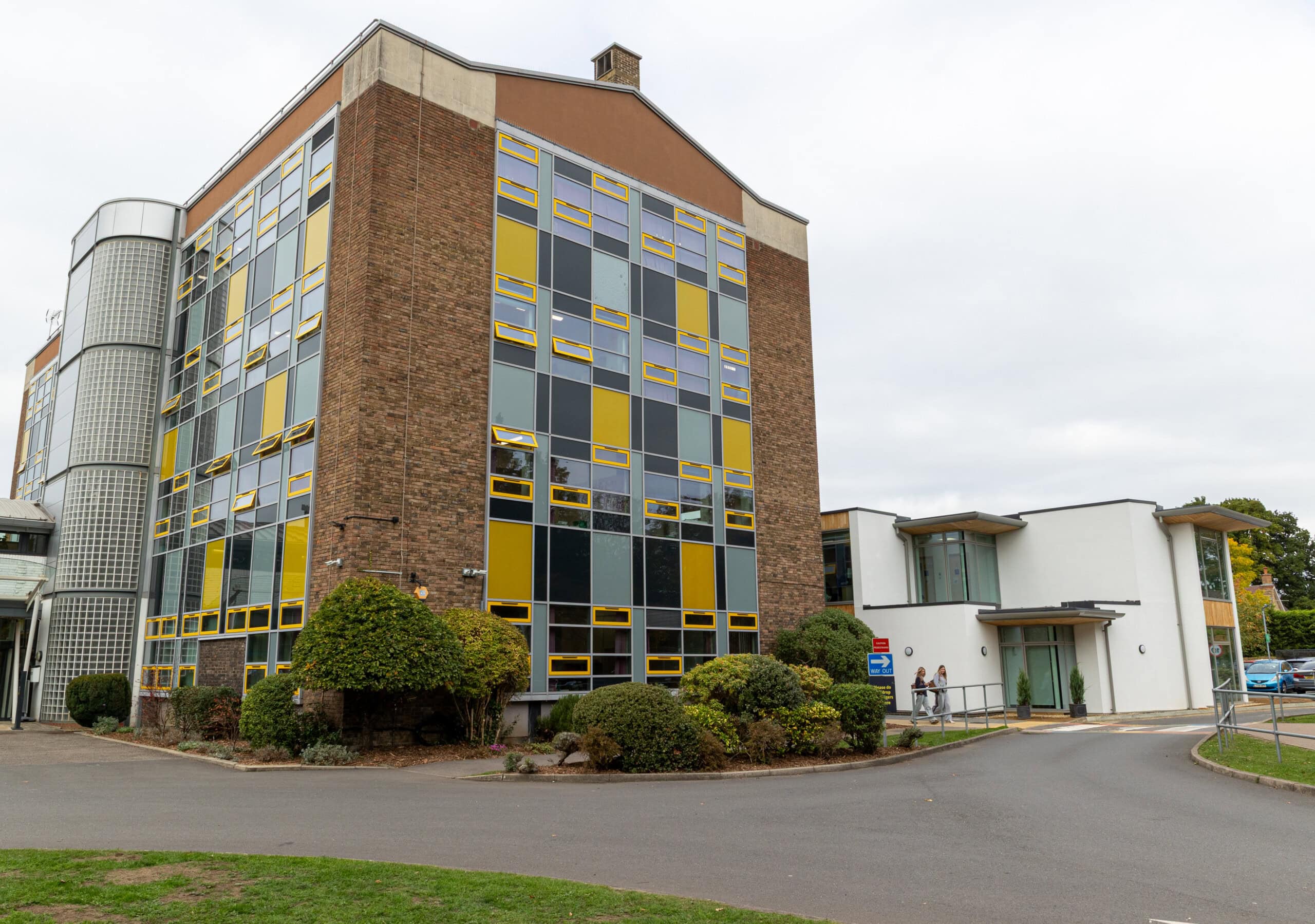 College Tower With Students Crossing