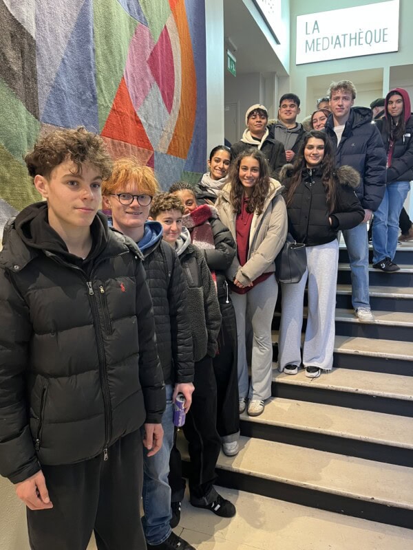 french students standin gon the staircase at the french cinema