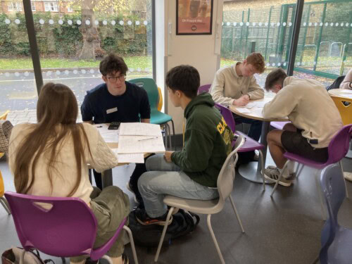 students sitting working at table sin the cafe area
