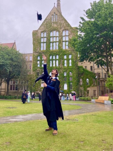 Joe on his Graduation day throwing his cap into the air
