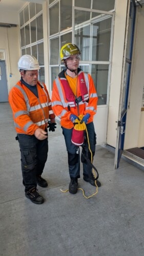 Harry Lines in a hard hat at work experience