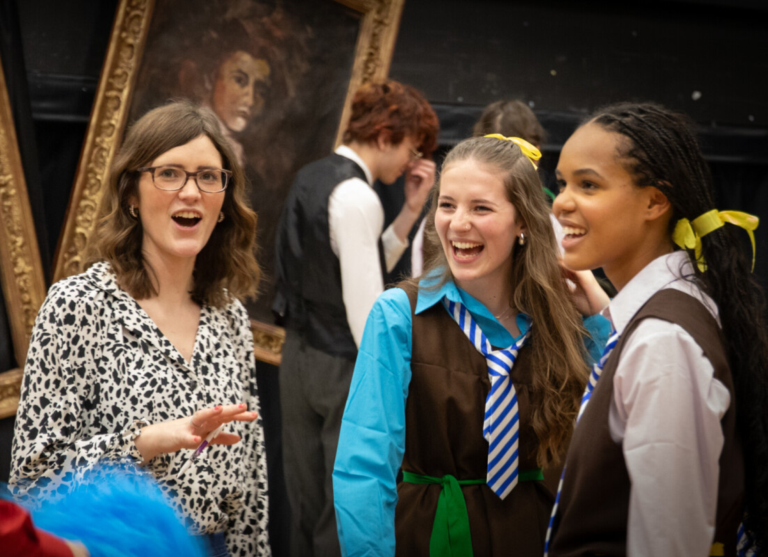 Drama Teacher with two students dressed as schoolgirls