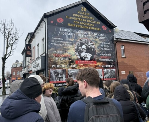 Students In Front Of Ira Sign