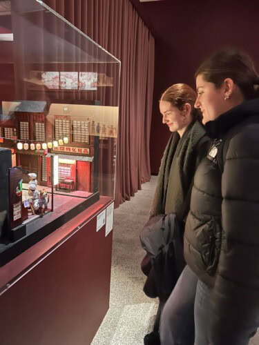 Students Observing Work At A Design Exhibtion