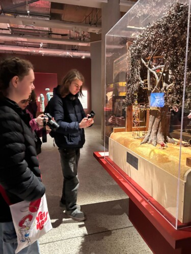 Students Photogrpahing Work At Exhibition