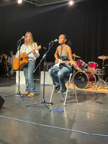 students performing a duet on stage