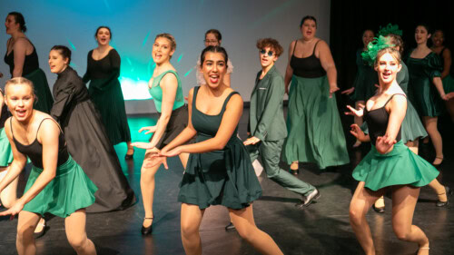 dance chorus dressed in green
