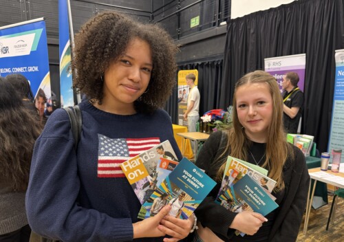 two female students holding prospectuses at the Apprenticeship fair
