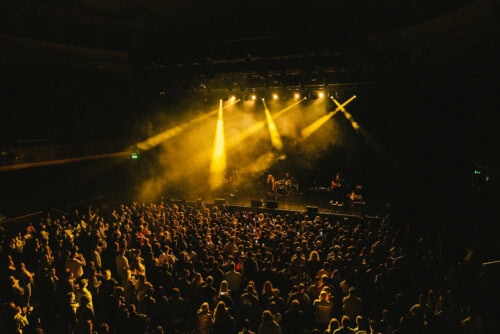 Callum performing live on stage to a large crowd