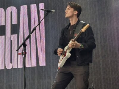 Callum performing guitar on stage