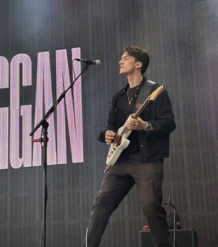 Callum performing guitar on stage