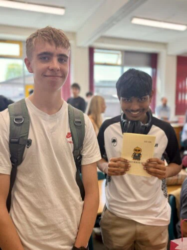 Maths students holding a thank you card