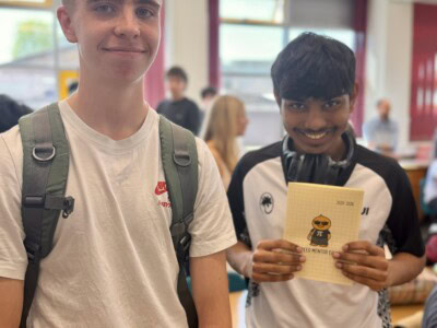 Maths students holding a thank you card