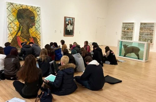 Art students drawing in a gallery