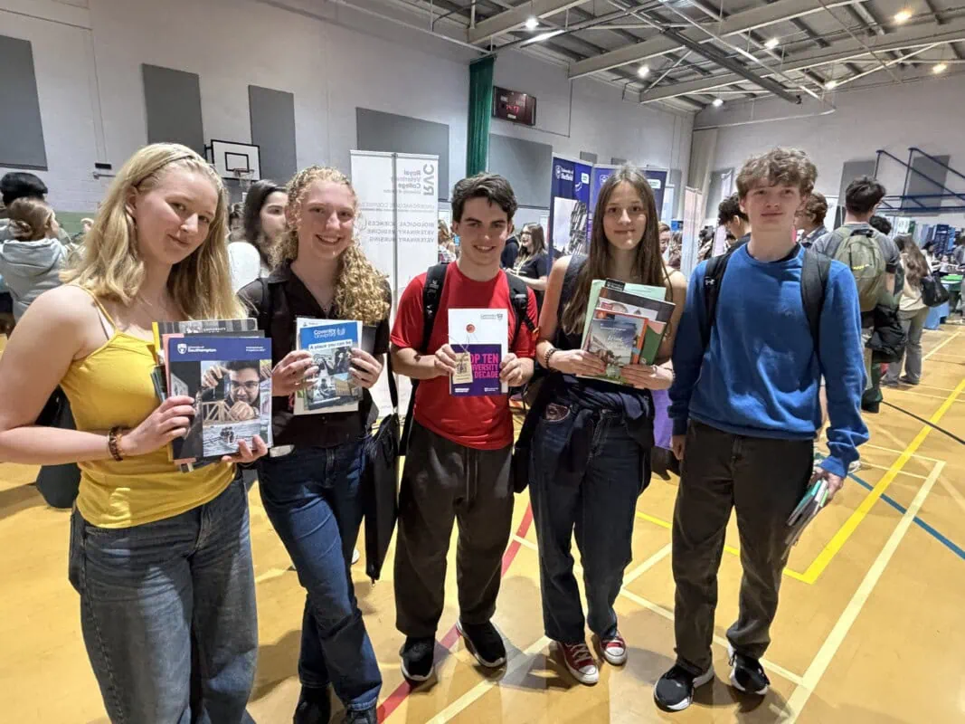 Group of students holding prospectuses