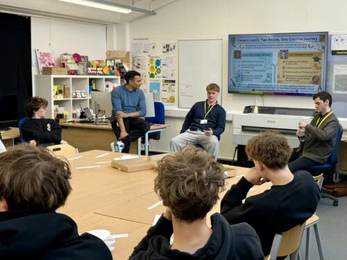 jose talking to alumni zak and lucas in a graphic communications classroom