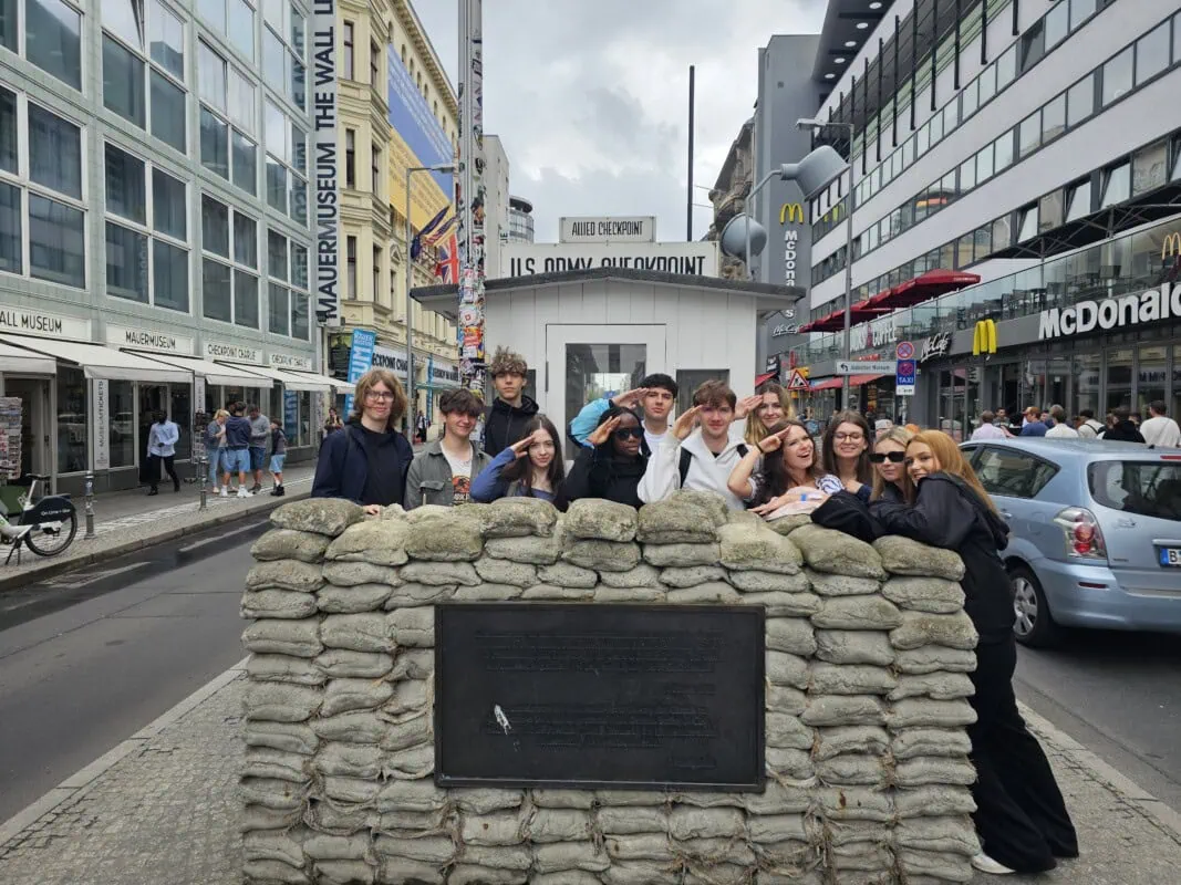 students at Checkpoint charlie in berlin