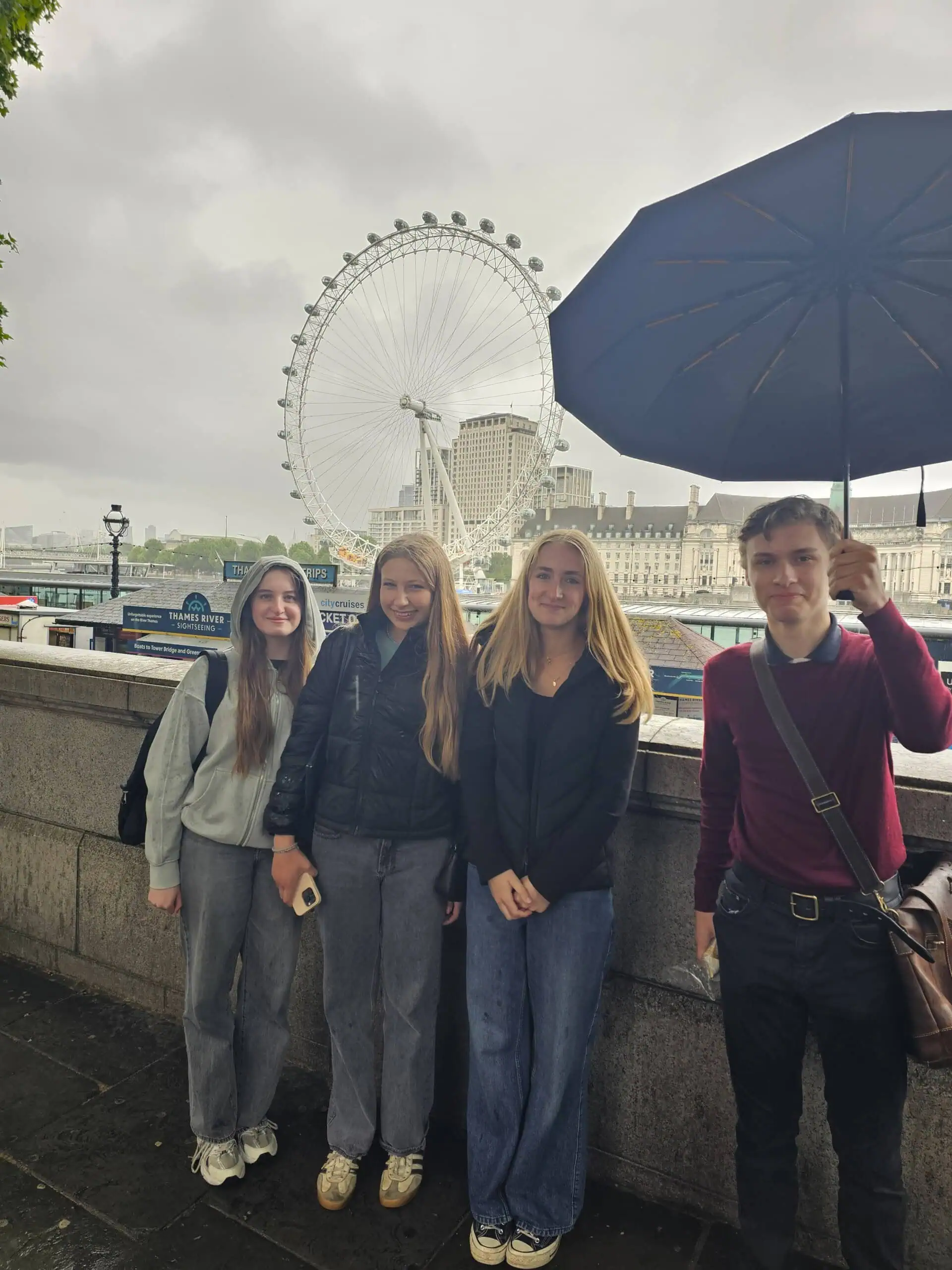 Students by the Thames overlooking westminster