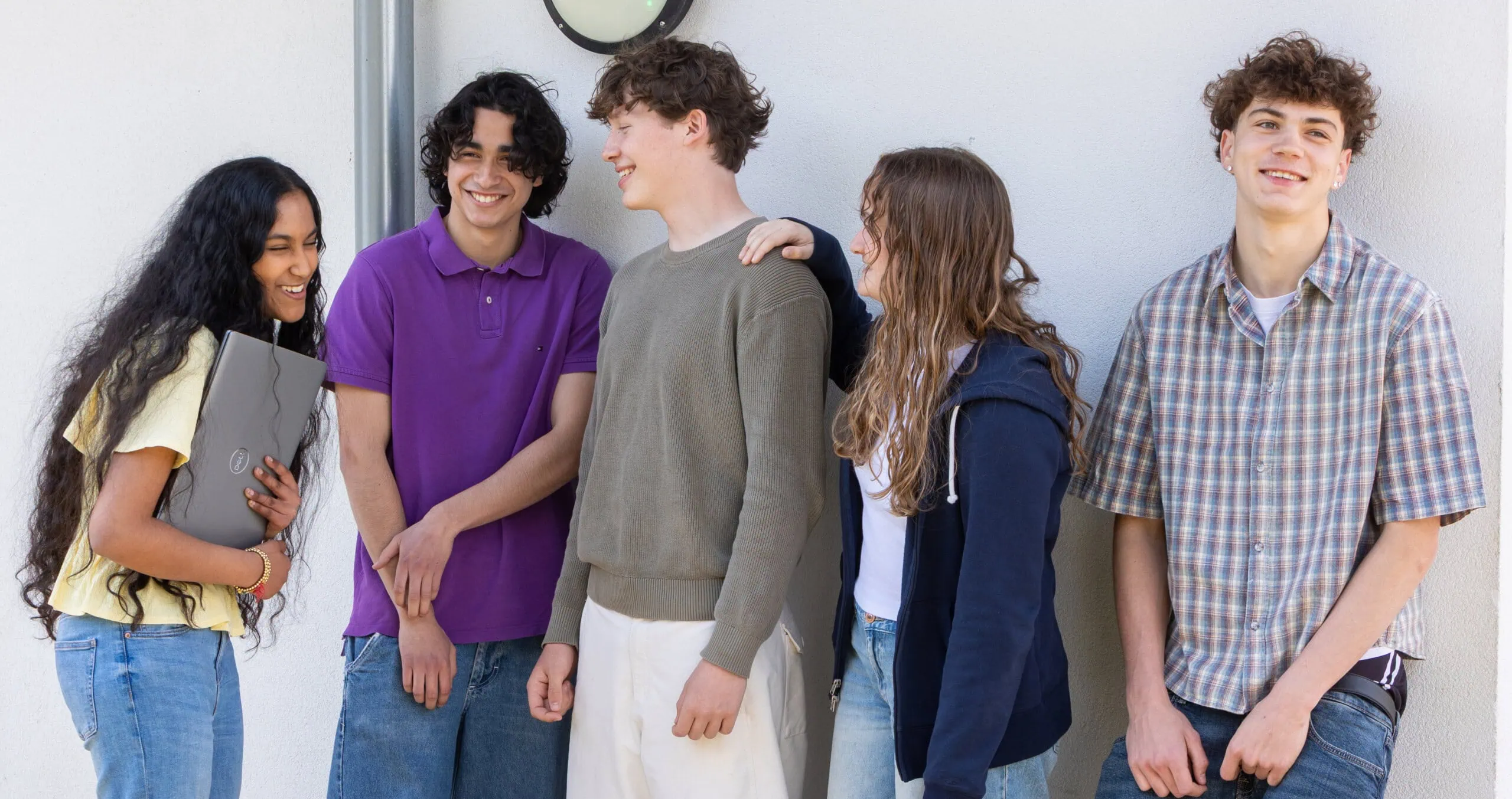 5 students chatting and laughing