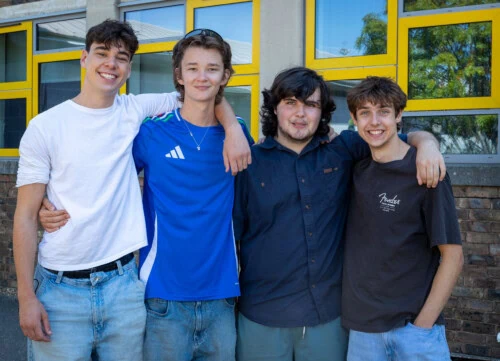four male film students stand shoulder to shoulder after getting their BTEC results 2026