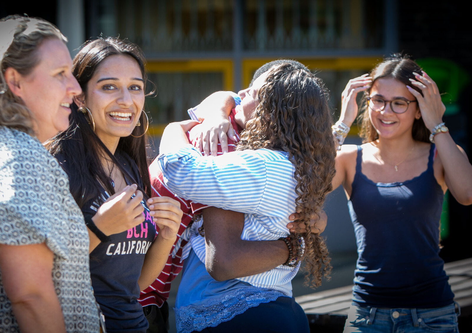 students have a celebratory hug on A Level results day