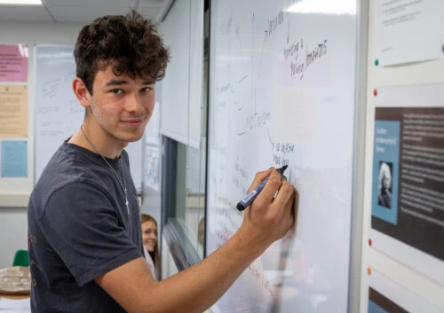 Student working at a whiteboard