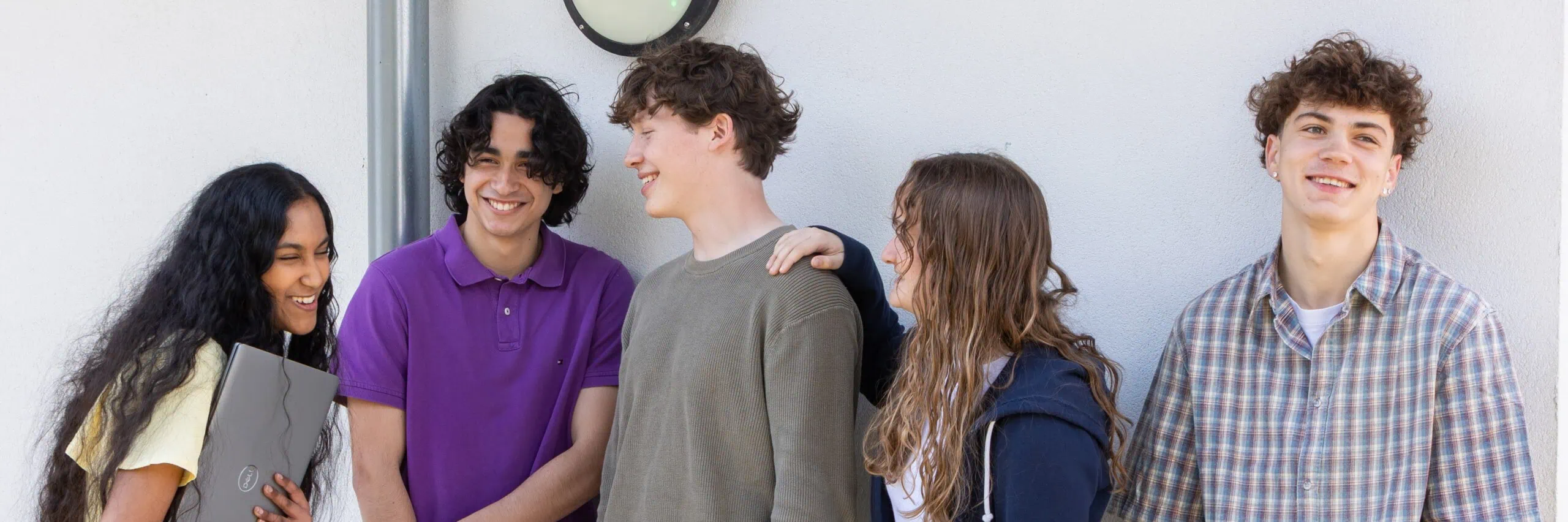 Group shot of students laughing and chatting