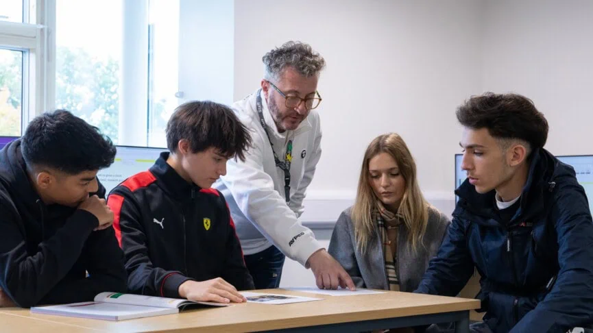 Glen teaching IT to a table of students